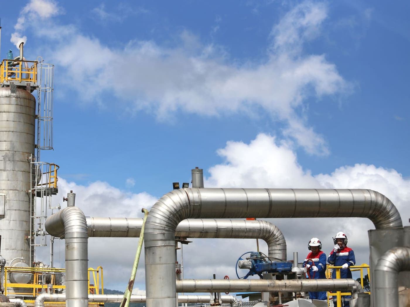 Two operators at a valve station in a gas plant